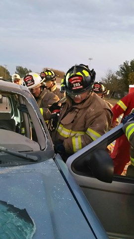 firefighter taking off the door of a car